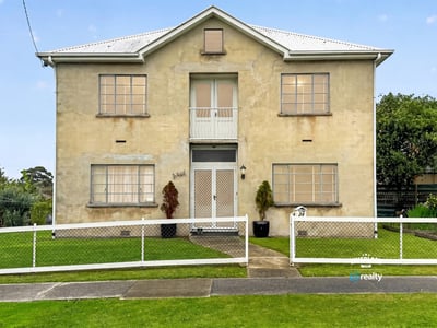 Spacious two-story residence featuring distinct architecture and ample outdoor space for relaxation and activities.
