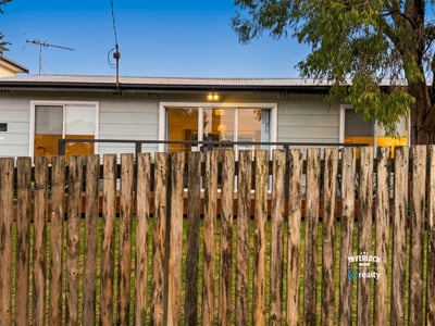 Cozy home with a welcoming front porch, perfect for enjoying outdoor moments in a friendly neighborhood.