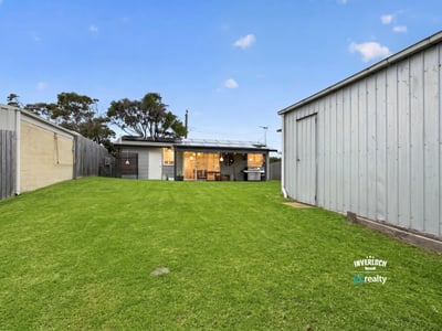 Spacious backyard perfect for outdoor activities, featuring a cozy home with modern amenities and ample storage.