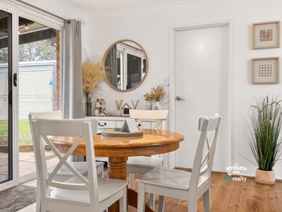Bright dining area featuring natural light, modern decor, and easy access to outdoor space.