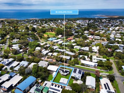 Discover a prime coastal property at 98 Anglers Road, surrounded by lush greenery and stunning ocean views.