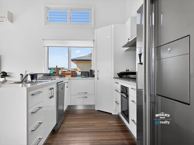 Bright and modern kitchen featuring sleek cabinetry and ample counter space, perfect for culinary enthusiasts.