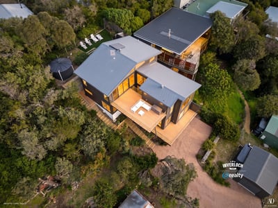 Spacious contemporary home nestled in nature, featuring expansive outdoor living areas and stunning views.