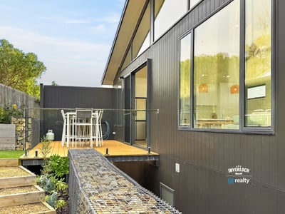 Modern home featuring an expansive deck, perfect for outdoor dining and enjoying scenic views.