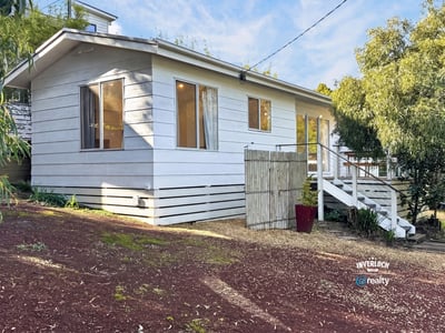 This inviting home features a spacious layout with large windows and a private outdoor area.