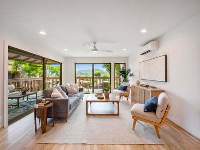 Bright and airy living space featuring large windows and sliding doors opening to a scenic balcony.