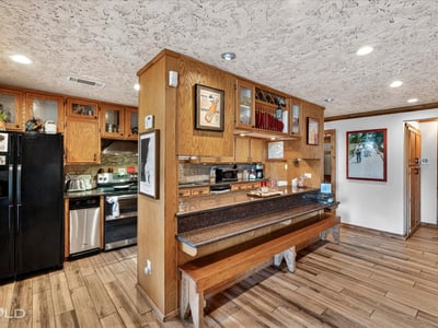 This inviting kitchen features ample cabinetry, modern appliances, and a cozy breakfast bar for casual dining.