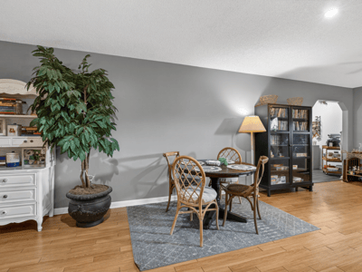 Bright and inviting living space featuring a cozy dining area and rich hardwood flooring throughout.