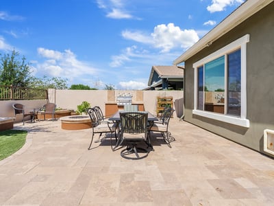 Host outdoor dinners in this entertainer s paradise, complete with a built-in grill, stone pavers, and a sleek modern design that blends with the Phoenix lifestyle.