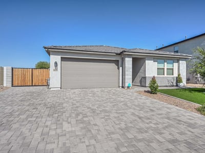 This eye-catching Peoria home showcases a sleek exterior design with a wide paver driveway, manicured synthetic turf, and a welcoming front entry. The spacious two-car garage and side RV gate offer added convenience and storage flexibility. Designed with curb appeal and low-maintenance living in mind, the home blends modern elegance with functional upgrades that enhance everyday living and energy efficiency.