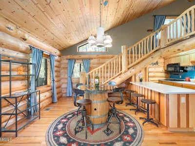 Bar seating area with solid counters and custom woodwork, connecting the kitchen to dining and living spaces for everyday use.