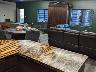 Inviting entertainment room featuring a handcrafted bar, open layout, and space for games or lounging. Designed for comfort and function, this area complements the home s rustic Prescott mountain style.