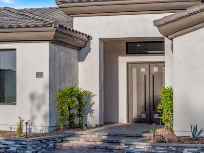 Modern double doors with glass accents make a bold statement at the entrance of this Scottsdale residence.