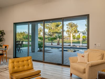 Sliding doors open to backyard views of the pool and golf course, filling the living area with light and Scottsdale charm.