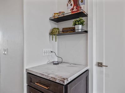 Built-in storage and charging station keep electronics organized, adding smart functionality to this Scottsdale home.