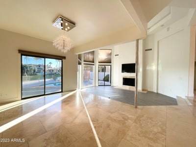 Sun-drenched living area featuring sliding doors to the patio and pool. Perfect for gatherings and relaxed lakefront living.