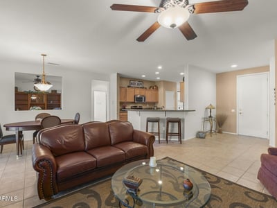 The open great room showcases tile flooring, neutral colors, and recessed lighting. Ideal for entertaining, it seamlessly connects to dining and kitchen spaces.