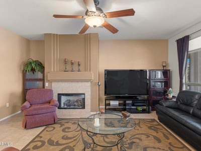 A perfect blend of spaciousness and comfort, this great room features abundant light, tile flooring, and neutral finishes ideal for both relaxation and entertaining.
