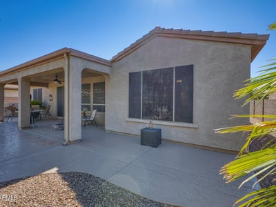 Enjoy the comfort of this covered patio space, complete with ceiling fan and desert views ideal for relaxation or casual gatherings.