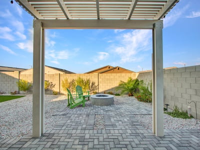 Enjoy mountain views, manicured landscaping, and a peaceful fire pit setting in this beautifully designed Litchfield Park backyard.