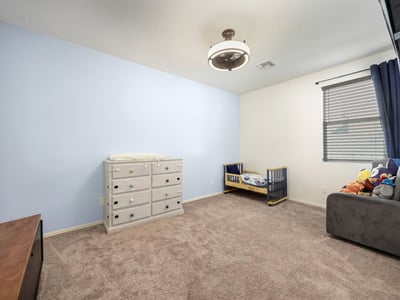 Flexible bedroom with tile floors and ceiling fan, suitable for a bedroom, home gym, or creative workspace.