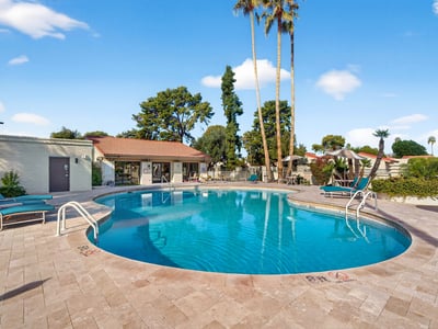 Spacious community pool area offering shaded seating, open sun areas, and a welcoming environment for leisure and relaxation.