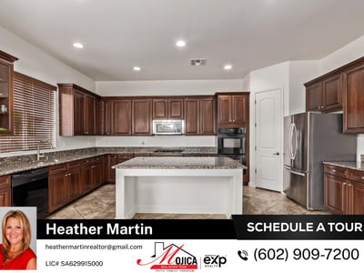 The large island and expansive granite surfaces provide ample workspace for cooking and entertaining. Rich cabinetry and built-in appliances enhance this Glendale property s appeal.
