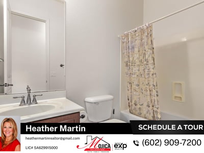 This clean and functional guest bathroom includes a full tub and shower, extended vanity, and wood cabinetry. A practical addition to this well-maintained Glendale home for sale.