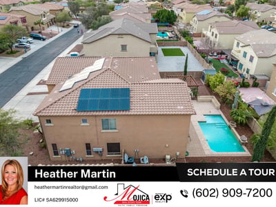 Top-down view showcases the extensive solar panel installation for energy efficiency. The tile roof and pool area enhance this Glendale home s overall appeal.