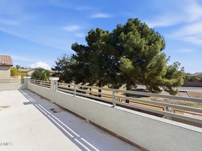 Private balcony with open views of the backyard and surrounding greenery, offering a peaceful place to enjoy fresh air and morning coffee.