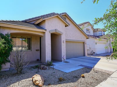 Angled exterior view highlighting the home s design, landscaping, and driveway. This Phoenix property offers appealing curb presence.