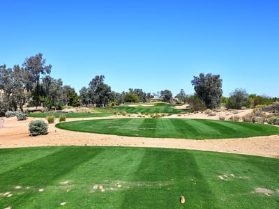 Expansive fairway with desert landscaping and mature trees. This Phoenix golf course community provides beautiful surroundings and recreational opportunities.