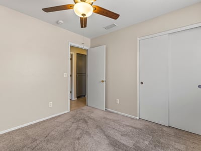 Inviting bedroom with neutral finishes, ceiling fan, and natural light ready for personalization.