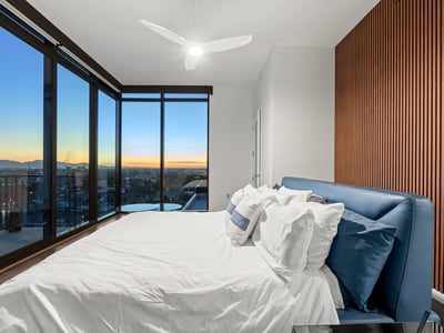 Spacious primary suite with balcony access, modern finishes, and expansive Phoenix views, offering a private and relaxing retreat.