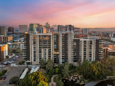 Expansive views blending city skyline with mountain backdrops at sunset, adding natural beauty to this Phoenix property.