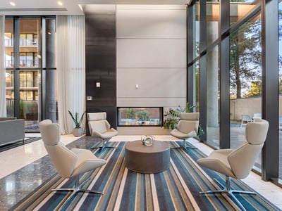 Inviting lounge area with a modern fireplace, plush seating, and elegant finishes, perfect for relaxing in Phoenix.