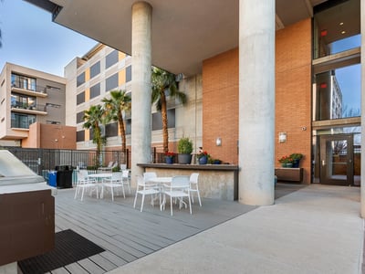 Outdoor patio with dining tables and grilling station, providing a functional space for gatherings in Phoenix.