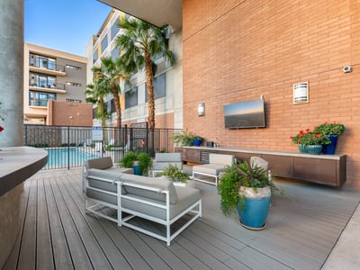 Poolside retreat featuring lounge seating, grilling area, and landscaped surroundings, offering resort-style amenities in Phoenix.