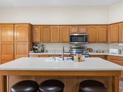 Bright kitchen and dining area with natural light, ample cabinetry, and open flow to living spaces in this Phoenix home.