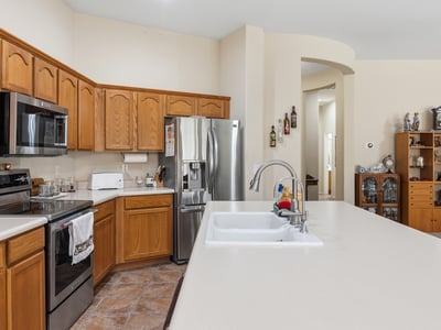 Kitchen featuring stainless steel appliances, spacious counters, and efficient layout, enhancing everyday living in this Phoenix property.