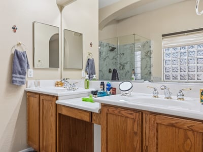 Bathroom featuring dual sinks, executive-height counters, and ample storage, designed for everyday convenience in this Phoenix property.