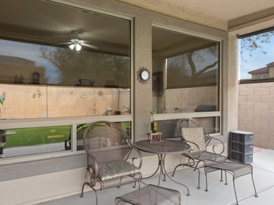 Shaded patio with seating area and privacy, creating a comfortable outdoor retreat perfect for entertaining in this Phoenix home.