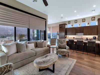 Flowing layout connecting living, dining, and kitchen spaces with abundant natural light ideal for entertaining in this Phoenix property.
