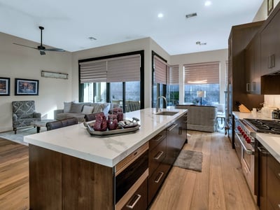Open kitchen with oversized island, quartz surfaces, and seamless flow into the living area perfect for entertaining in this Phoenix home.