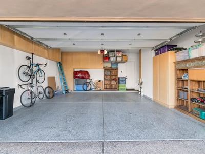Functional garage space with built-in cabinets, storage solutions, and room for vehicles and hobbies in this Phoenix property.