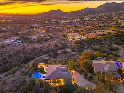 Scottsdale aerial capturing expansive desert views, surrounding homes, and vibrant sunset colors.