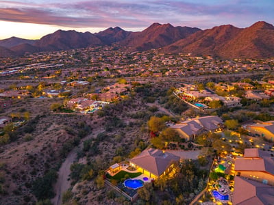 Scottsdale aerial showcasing natural desert terrain, nearby homes, and open space enhancing privacy and views.