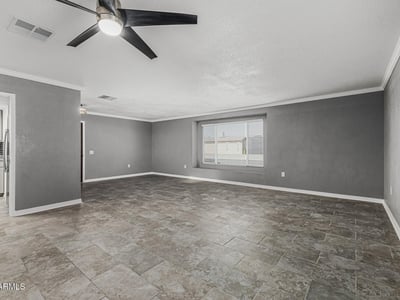 Open living room with natural light, neutral tones, and updated finishes. This Sun City home is move-in ready with a functional layout.