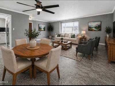 Stylish open concept living and dining space with modern flooring and ceiling fan. This Sun City home features updated interiors perfect for entertaining and everyday comfort