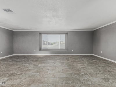 Light-filled living room with updated flooring and large window. This Sun City home offers a clean, modern feel with move-in ready convenience.